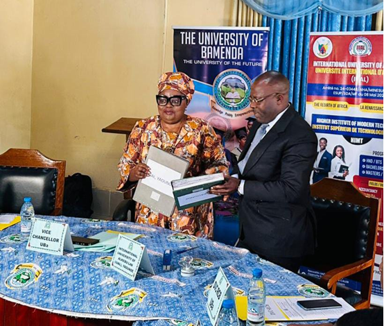 Mejang-Vincent-Board-Chair-exchanging-documents-of-the-MoU-with-UBa